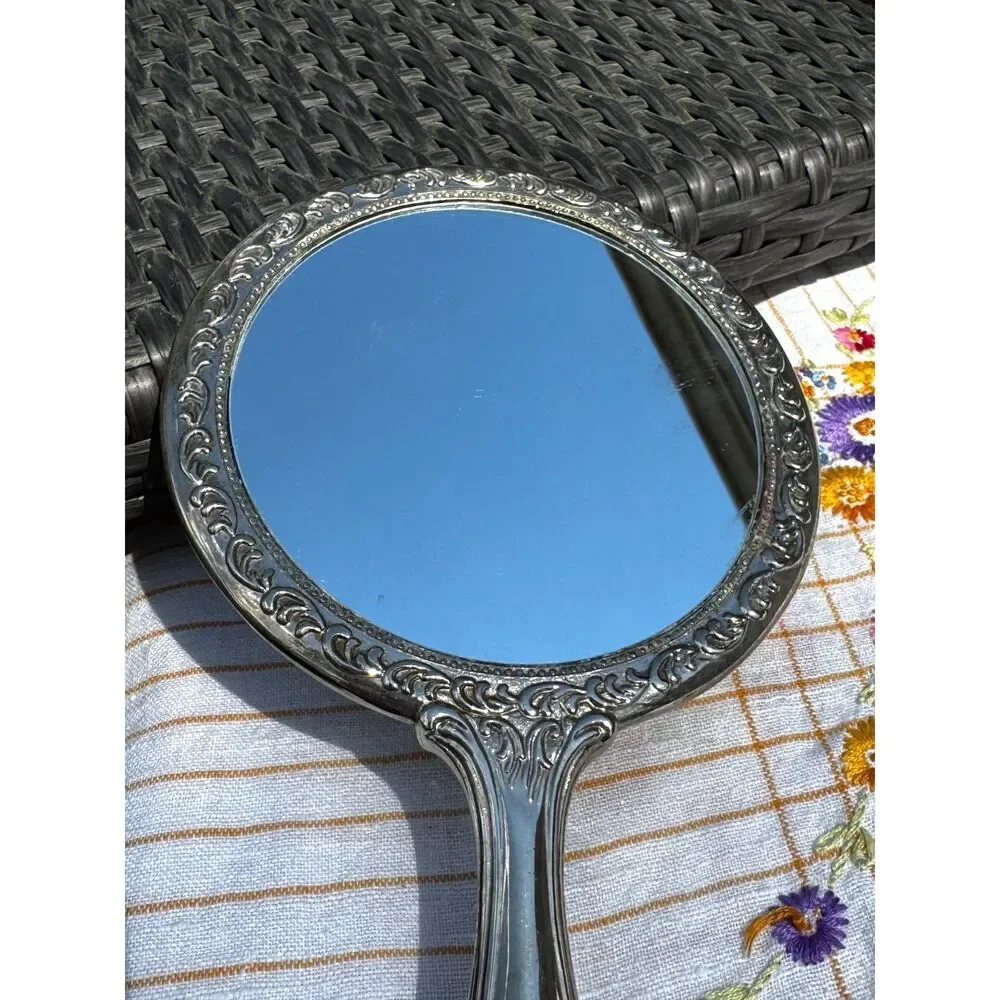 Vintage silver tone hand mirror embossed design on back so pretty
